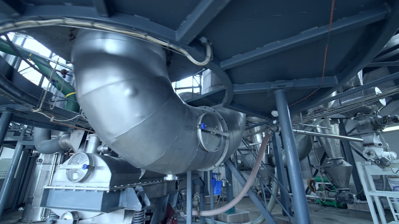 Modern technology of milk producing factory. Stainless diary industrial equipment.