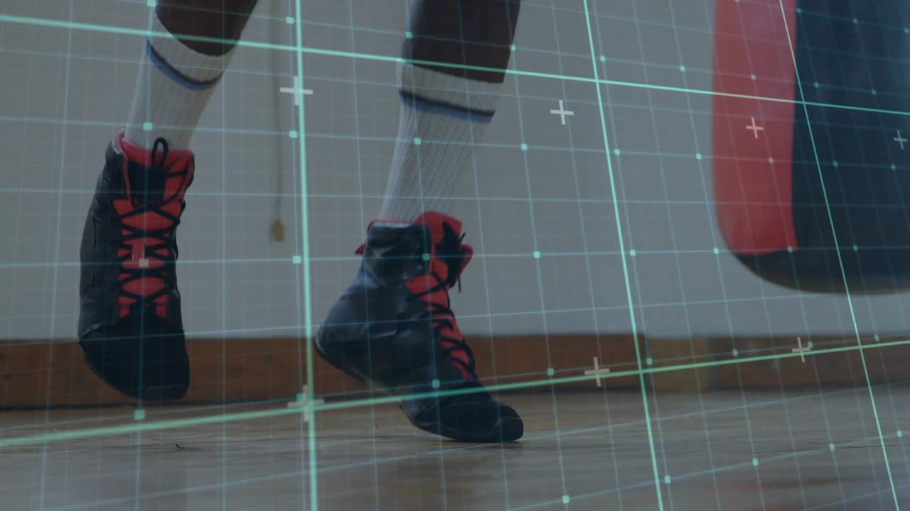 Mature athlete tying red laces, initiating boxing steps beside heavy bag to prep, teal grid overlay