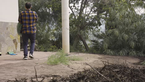 caucasian man cleaning the garden and take out plastic bags of trash biological waste recyclable bottles garbage bin