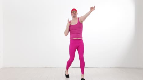 man in pink outfit posing and dancing with positive gestures
