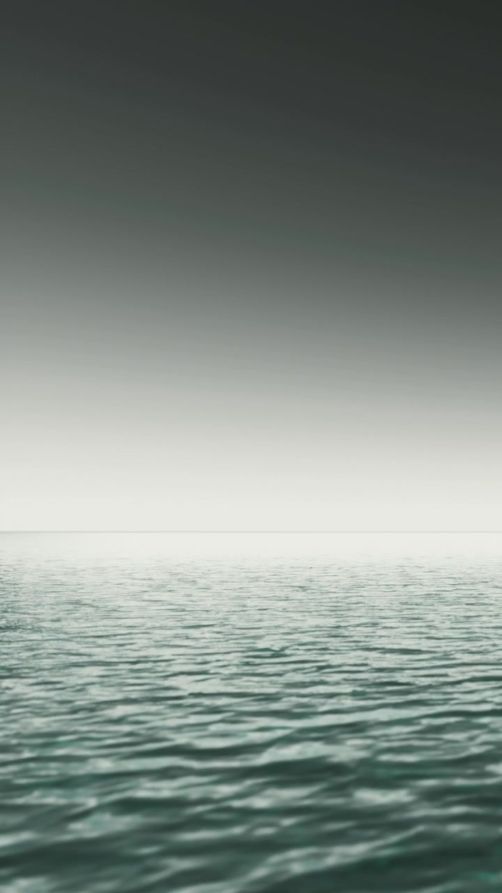 Ocean surface meets sky near the horizon in soft light at dawn