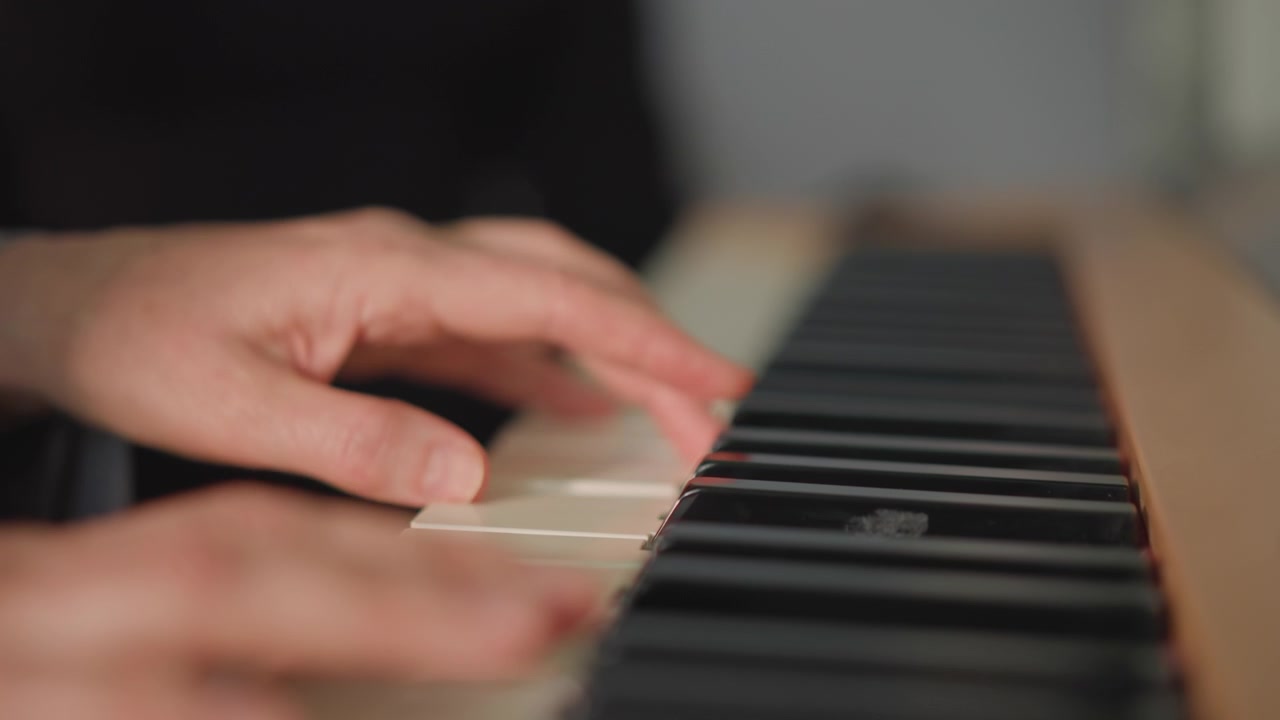 Expert pianist fingers pressing keys carefully. Concentrated hands demonstrating refined piano fingering technique. Playful yet precise finger movements on piano strings with delicate control