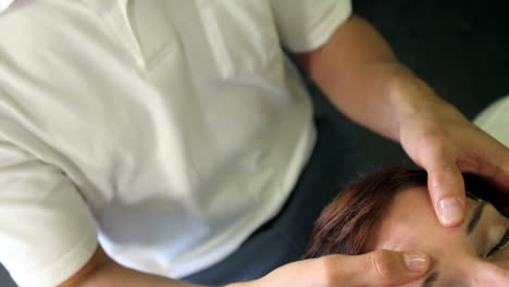 physiotherapist giving head massage to a female patient