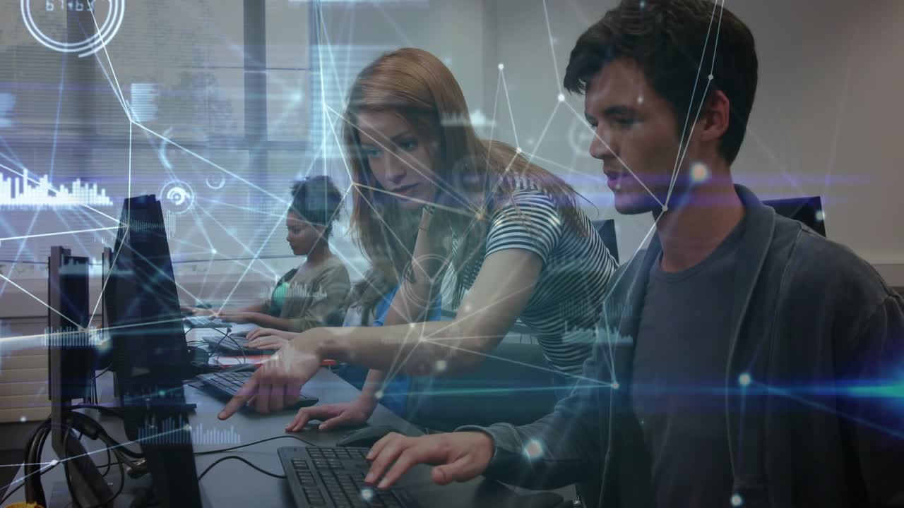 Woman leaning over man pointing at monitor in tech lab, guiding while animated nodes marking charts