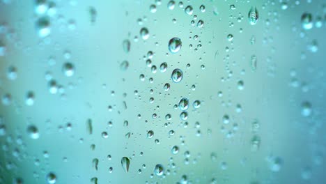 beautiful blue background with raindrops. transparent drops of water on a glass window in rainy weather. close-up.
