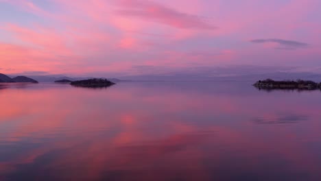 stunning landscape shot of orange and purple sunset reflecting in lake