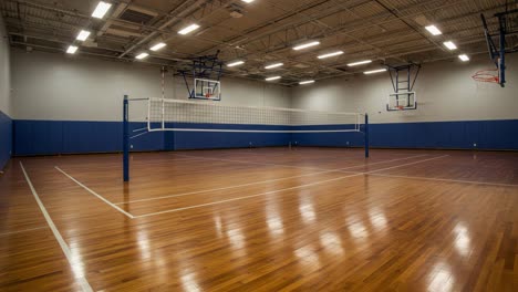 a spacious indoor volleyball court ready for action, featuring smooth wooden flooring and clear netting for engaging matches and competitive play