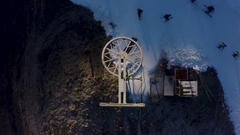 4K-aerial-drone-grassy-CINEMATIC-top-down-shot-of-skiers-getting-off-a-chairlift