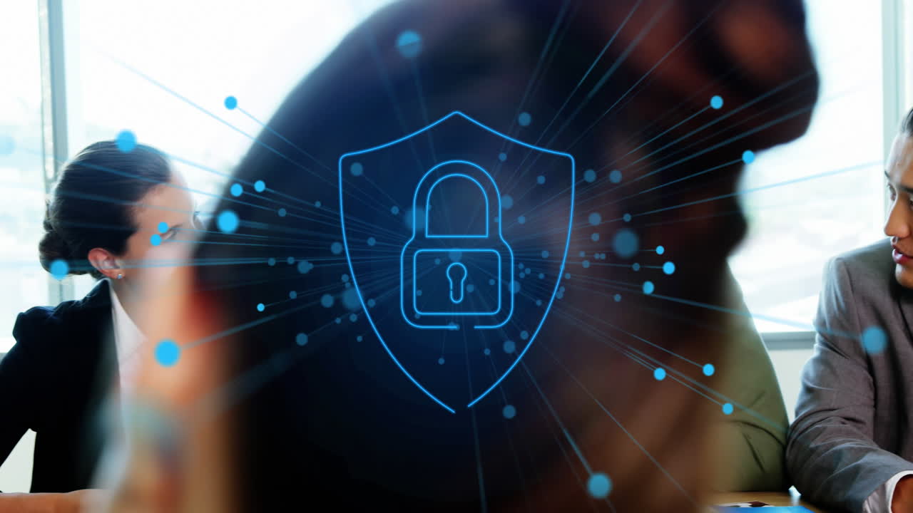 Animation of dots around padlock in shield, diverse coworkers discussing strategy in office