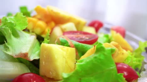 organic green salad with various kinds of fruits in rotating macro shot - healthy lifestyle