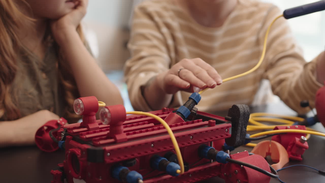 Two People Constructing Robot