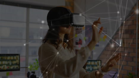 woman wearing vr headset interacting with virtual network in office, with floating glowing nodes