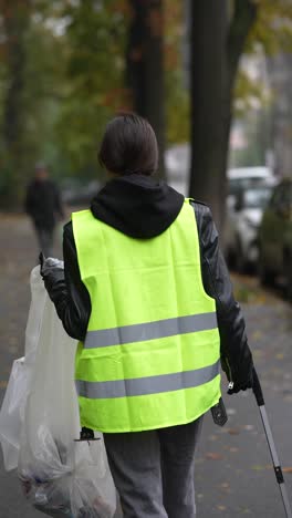 woman cleaning up litter on the street