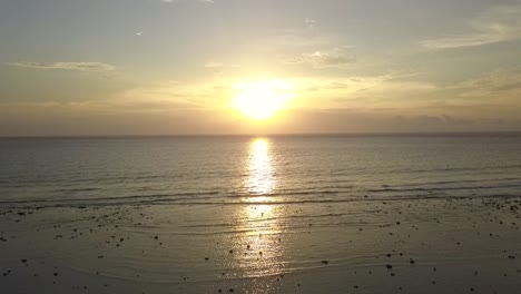 infinity sun reflected in sea
daring aerial view flight panorama overview drone footage
of gili t beach bali indonesia at sunset summer 2017