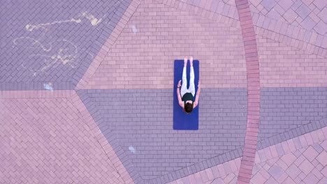 women-doing-outdoor-Pilates-near-waterfront-during-summer