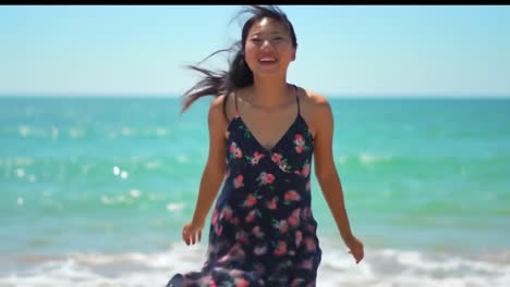 A Young Woman Enjoying the Beach: A Journey of Joy and Freedom as She Embraces the Ocean Breeze and Sunlight in a Floral Dress by the Shoreline