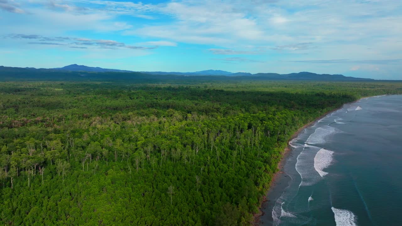 Untouched remote pristine coastline waves Cape Wom Papua New Guinea PNG aerial drone Madang Wewak Kavieng Vanimo Tufi sunny beach blue sky tranquil tropical shoreline East Sepik Province forward