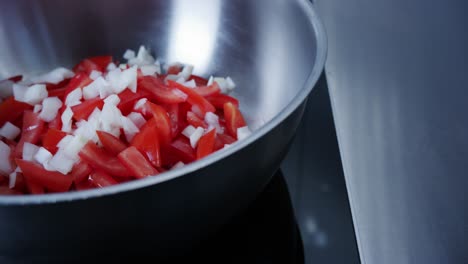 A-camera-moves-over-tomatoes-and-onions-in-a-pan-ready-to-be-made-into-tomato-sauce