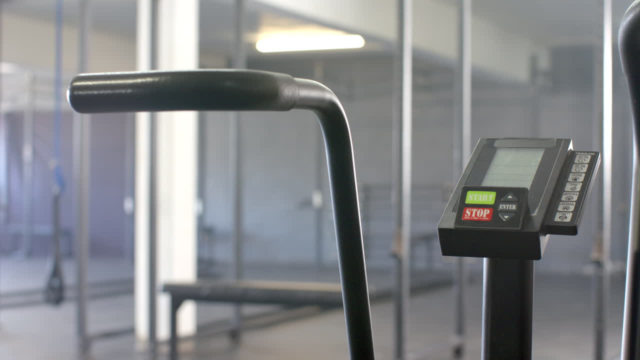 Exercise bike in gym with digital display showing start and stop buttons