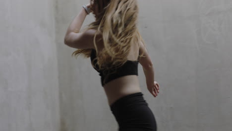 dancing-woman-beautiful-young-caucasian-street-dancer-performing-contemporary-moves-enjoying-modern-dance-expression-practicing-in-grungy-warehouse-close-up