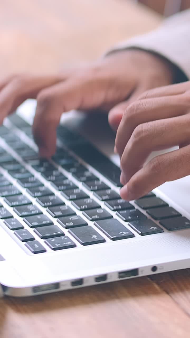 Laptop typing session by african american individual in a cozy workspace