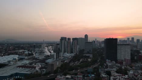 Drone-shot-of-the-Modelo-brewery-in-Mexico-City-with-Polanco-and-Periferico-on-the-background-in-4K-during-golden-hour-at-sunrise