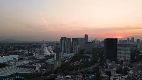 drone shot of the modelo brewery in mexico city with polanco and periferico on the background in 4k during golden hour at sunrise