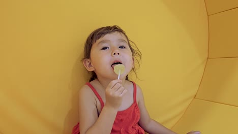 Happy-Smiling-Child-Girl-Eating-Lollipop
