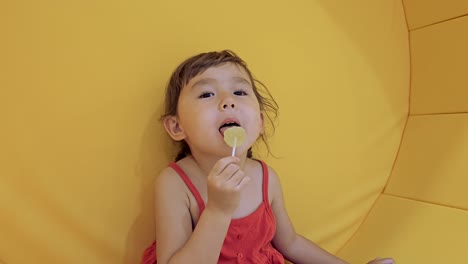 happy smiling child girl eating lollipop