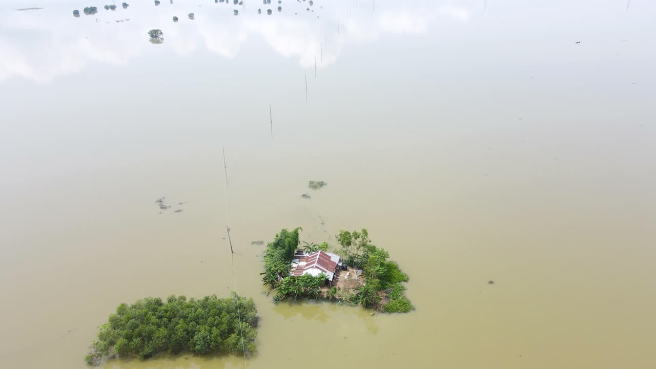 Aerial shot of severe flood in haor region of Bangladesh. Home submerged by floodwater