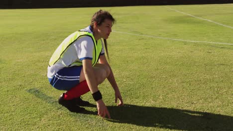 Female-soccer-player-explaining-strategy-while-sitting-in-squat-position.-4k