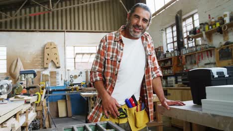 smiling carpenter fixing the camera