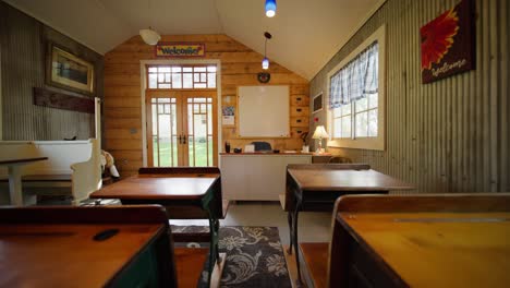 push in shot down the row of vintage school desks in an old school house classroom