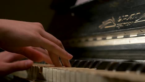 close-up of hands playing vintage piano