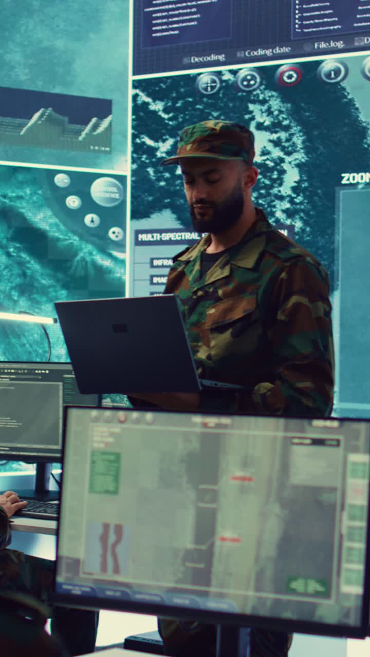 Soldier in Camouflage Uniform Working on Laptop in Control Room