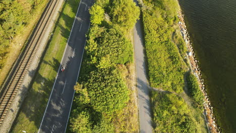 Highway-road,-railroad,-and-walking-pedestrian-path-in-Kuznica-tourist-spot-in-Hel-Peninsula,-Poland,-baltic-sea,-Slow-revealing-shot-by-tilting-the-camera-up