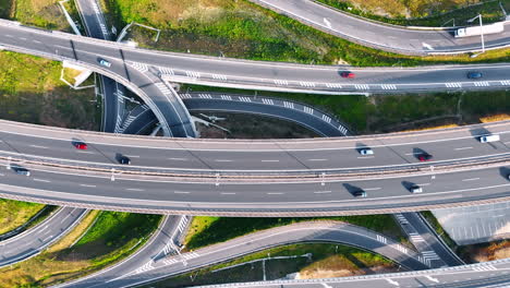 traffic on highway interchange. cars navigate a busy and intricate highway interchange during daytime, showcasing multiple road levels and routes