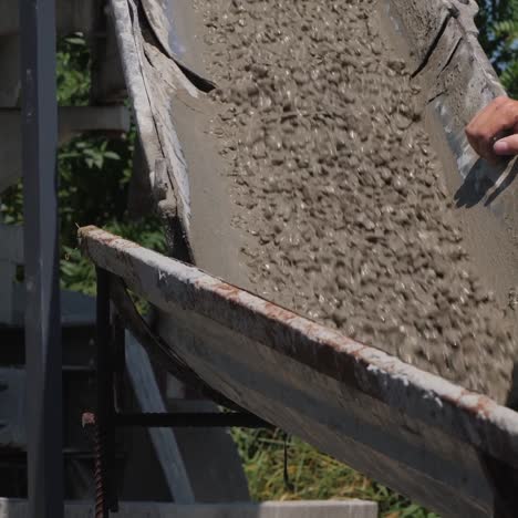 foreman controls the flow of liquid concrete from the chute