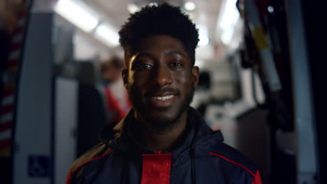 portrait of african american paramedic smiling at camera