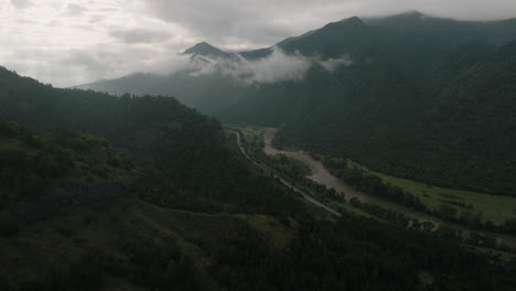 flyover above a road alongside the kura river, hidden in dark georgian valley