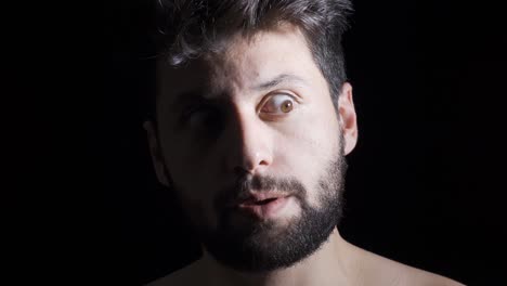 mentally ill man on black background, mental disorders and hallucinations.