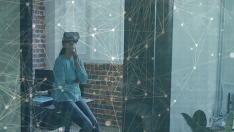 Animation of networks of connections over businesswoman with vr headset in office