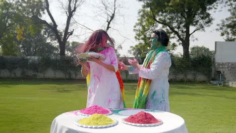 indian man silently put colors on his wife on holi