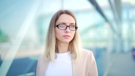 close up portrait young blonde business woman with glasses looking at camera smiling face happy female businesswoman