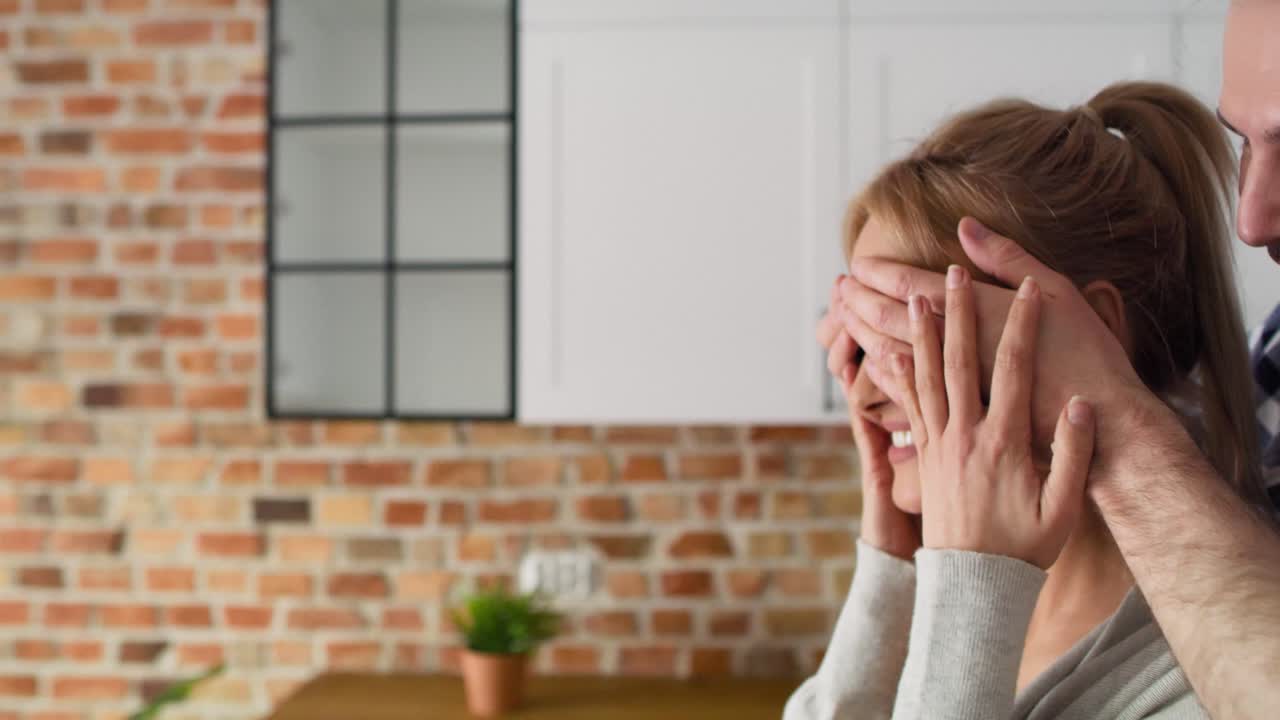 Tracking video of man surprising woman in new flat