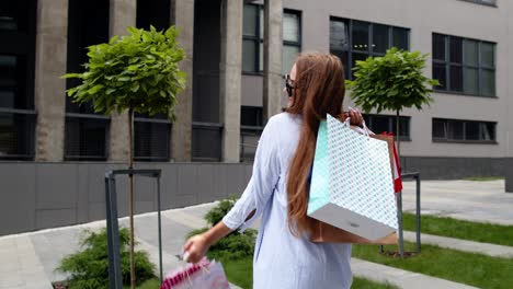 Girl-holding-colorful-shopping-bags,-rejoicing-discounts-in-fashion-store,-enjoying-shopping