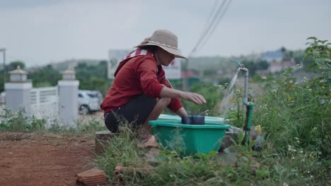 woman washing clothes outdoors