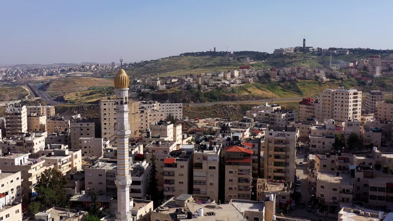 Aerial View of a Middle Eastern City with Prominent Mosque Minaret