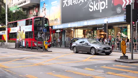 pedestrians and vehicles at a bustling intersection