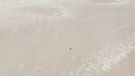 aerial view of woman walking on salt lake in türkiye